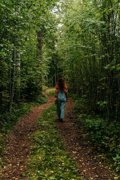 woman walk on forest path