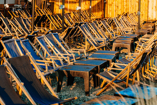 Rows of beach chairs in the early sunny morning before the cafe opens