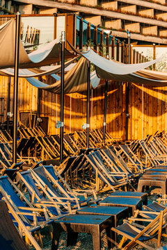Lots of rows with sun loungers in the morning sunlight