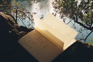 Journal pages open in the wind to a handwritten quote