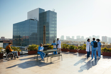 Diverse medical team taking a break on hospital terrace