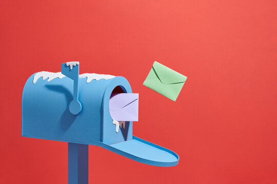 A mailbox with the flying envelopes under snow