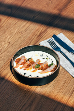 Sunlit Savory Dish with Shrimps on Wooden Surface