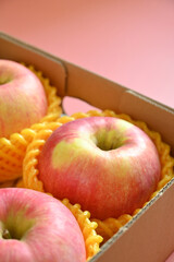 beautiful pink apple in the box on pink background