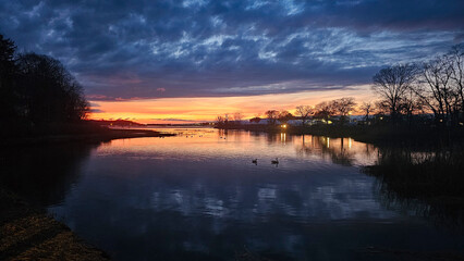 Captivating Long Island sunset landscapes over tranquil waters near Port Jefferson, showcasing a...