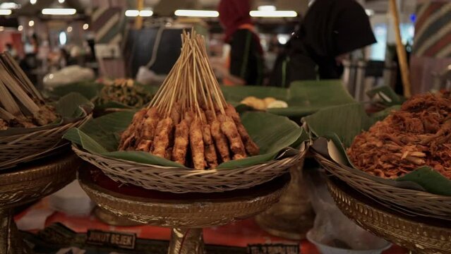 Gilimanuk Balinese typical rice and side dishes on a rattan plate covered with banana leaves