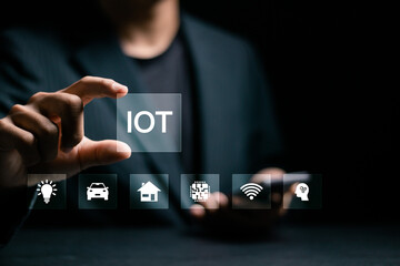 Smart business IOT, internet of things concept. Businessman touching IOT icon on virtual screen for...