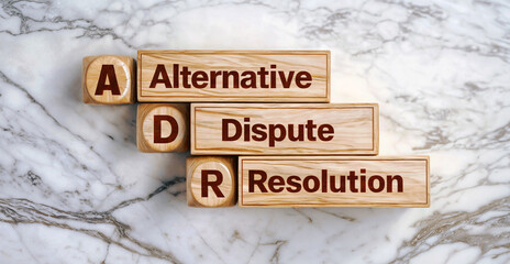 Wooden cube blocks of word text Alternative Dispute Resolution acronym DR on white marble background