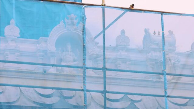 Restoration of an Indian temple. Restoration scaffolding. The temple is closed for restoration. Painting of the temple. The building is being painted.The building is undergoing facade restoration.