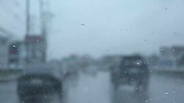 car is driving on the road in rainny day