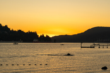 beautiful sunset view at Burrard Inlet mountains and calm water