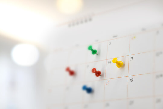 Pin on blank desk calendar in office workplace concept time management event planner or personal organization for business meeting and appointment reminder and schedule planning or holiday plan.