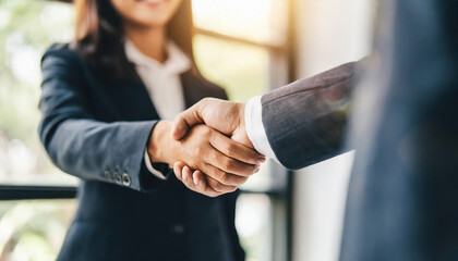 successful businessmen shaking hands with focus on women's hands in agreement