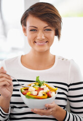 Obraz na płótnie Canvas Woman, diet and salad in portrait with healthy food for detox, breakfast and lunch at home. Young person eating green fruits, vegetables and lettuce or vegan meal in bowl for nutrition and wellness
