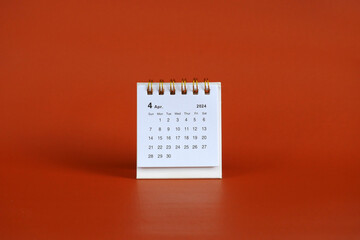 April 2024 month calendar on soft red background