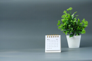 April 2024 desk calendar on a gray background