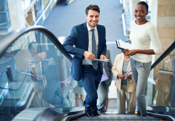 Teamwork, portrait or business people on escalator for meeting, travel or paperwork in workplace. Diversity, document or happy workers planning for collaboration, report or project together in office
