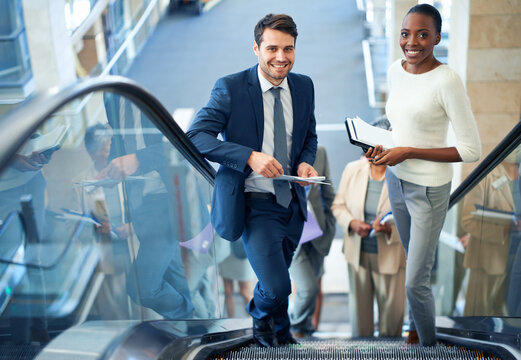 Teamwork, portrait or business people on escalator for meeting, travel or paperwork in workplace. Diversity, document or happy workers planning for collaboration, report or project together in office