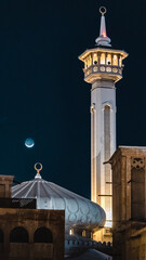 mosque in Dubai at night with crescent moon during Ramadan