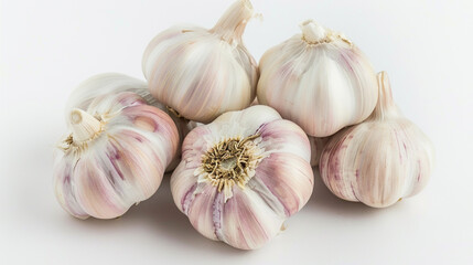 Several cloves of garlic arranged neatly on a pristine white background