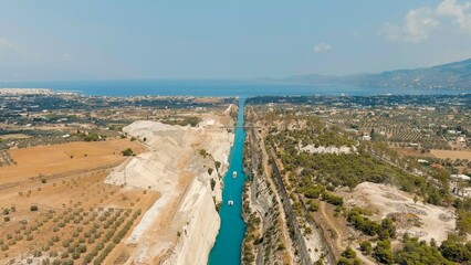 Corinth Canal, Greece. The Corinth Canal is a sluiceless shipping canal in Greece, connecting the Saronic Gulf of the Aegean and the Gulf of Corinth of the Ionian Sea, Aerial View