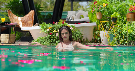 Indian Asian Hindu happy young adult gen z wet female lady relax pool enjoy fun joy resort park...