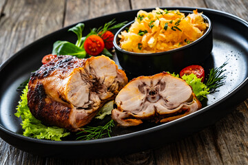 Baked rabbit saddle and vegetable salad on wooden table
