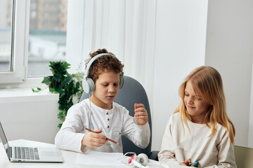 Happy Caucasian Children Using Laptops for Online Learning at Home