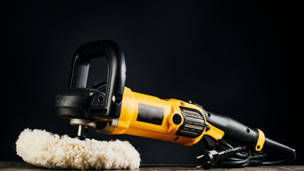 Car polishing machine on dark background.