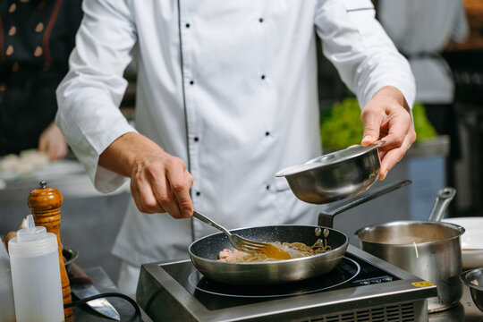The chef cooks in a professional kitchen