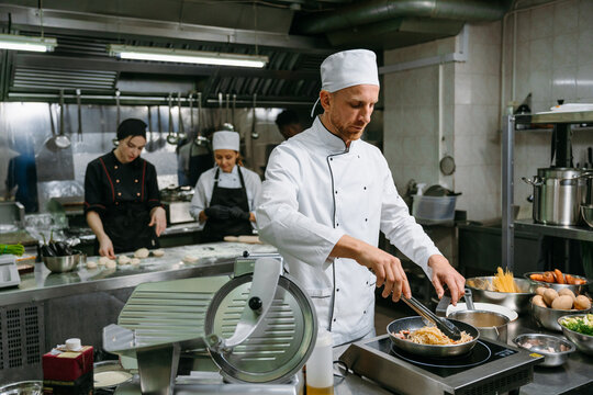 The chef cooks in a professional kitchen