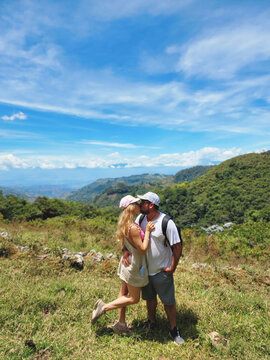young couple kissing in the mountains