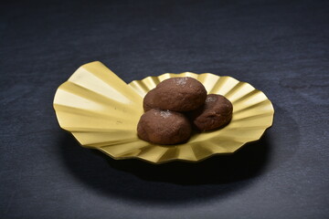 baked luxury dark chocolate coffee cocoa cookies with chocolate chip Himalaya rock salt and gold black plate gold fork knife on dark background pastry dessert halal vegan party food menu gluten free