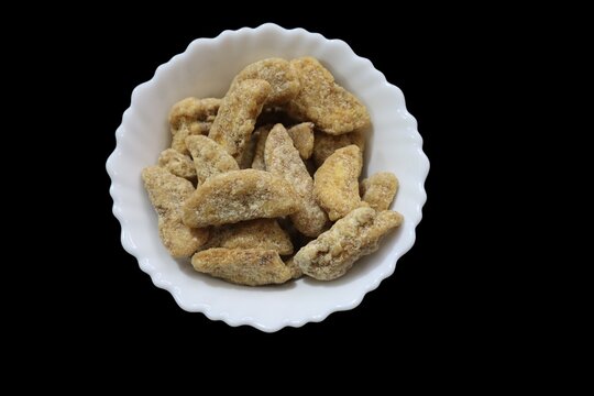 Kerala sharkara upperi jaggery coated banana chips sharkara varatti upperi with wooden background