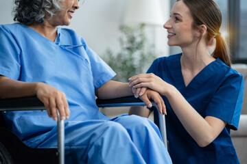 senior woman doing exercise at clinic with physiotherapist. help of a personal trainer during a...
