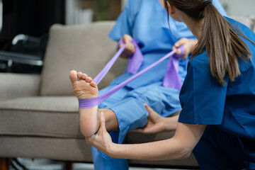 senior woman doing exercise at clinic with physiotherapist. help of a personal trainer during a rehabilitation session.
