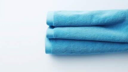 Blue cotton towels on a white background. Bathroom decor and accessories.