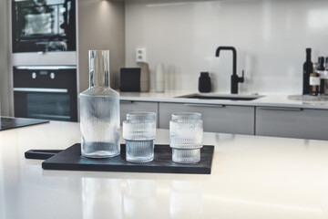 Fototapeta na wymiar glass of water on kitchen counter, kitchen interior