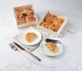 gourmet freshly bake golden Texas chocolate pope tea honey biscuit bun cake scone milk butter bread in square bento wood box on white marble table rose gold fork knife pastry halal dessert vegan menu