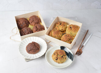 gourmet freshly bake golden Texas chocolate pope tea honey biscuit bun cake scone milk butter bread in square bento wood box on white marble table rose gold fork knife pastry halal dessert vegan menu