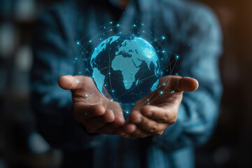 A business man holds in his hands a small virtual globe depicting the Earth. Business globalization, world trade concept