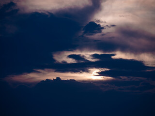 Rising Sun behind The Dark Streaming Clouds