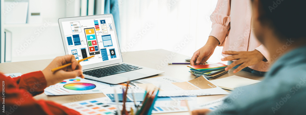 Poster cropped image of interior designer team presents color by using color swatches while laptop displaye