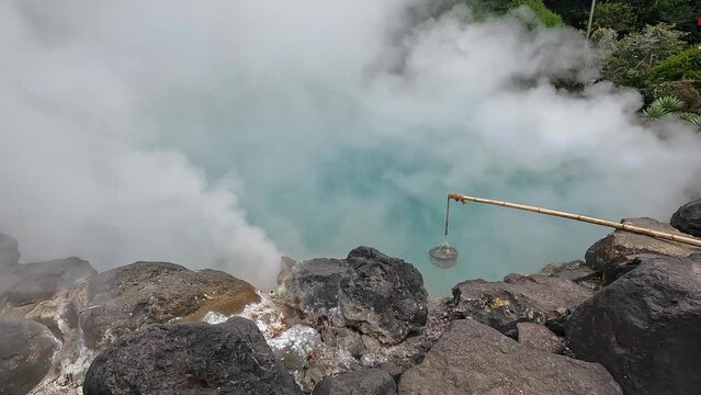 Landscape Umi Jigoku is largest among the Beppu Jigoku hot springs. The beautiful cobalt blue color is due to iron sulphate in the hot spring water Beppu Oita Japan 