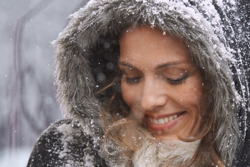 Woman, happy and eyes closed in nature with snow, winter season with fur coat for fashion, good mood and outdoor. Peace, calm and cold with comfort in jacket for weather, ice or frozen with smile