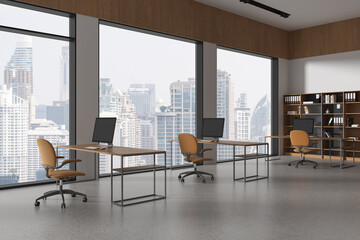 Stylish business interior with pc monitors on table, shelf near panoramic window