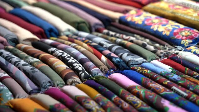 Multicolored textiles on the counter of the store 4K