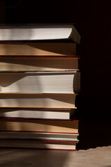 stack of books with abstract shadows
