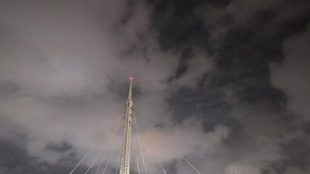 At night, billowing clouds fly over the lightning rod. The lightning, wide sky and billowing clouds form a spectacular high quality video. Kaohsiung City, Taiwan. 4K. Time lapse
