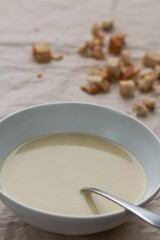 Leek cream soup with spoon.